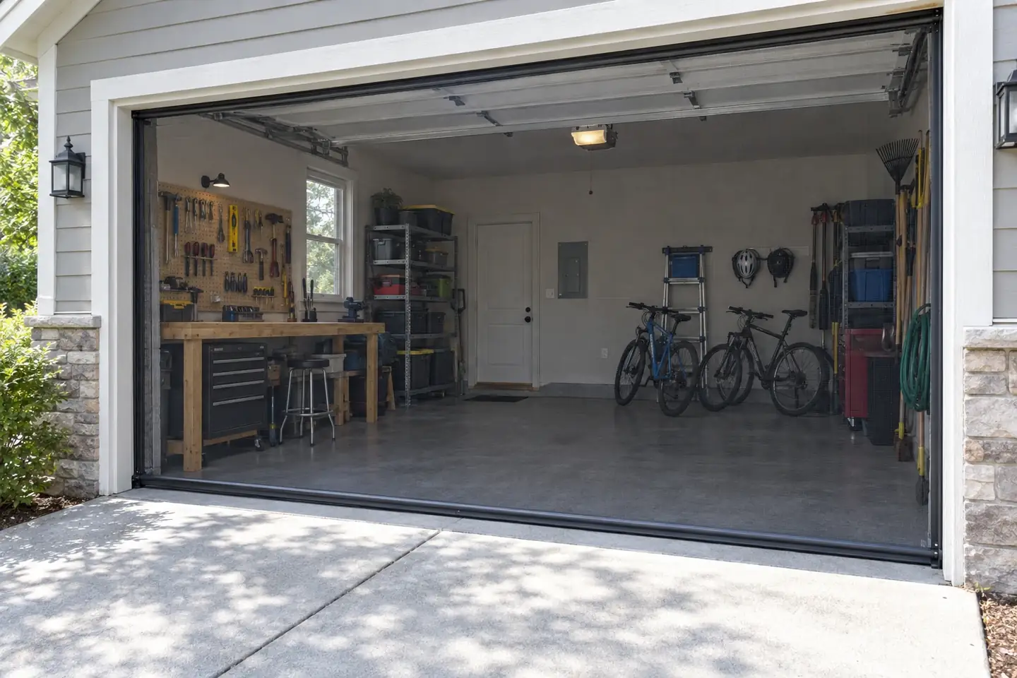 Open garage with a retractable screen lowered across the opening